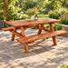 A rustic wooden picnic table with two attached benches, shown from a three-quarters angle on a solid white background.