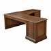 A dark brown wooden L-shaped desk with a curved writing surface, a left side cabinet with paneling and drawers, and a right pedestal base with decorative trim, shown on a plain white background.