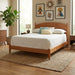 A mid-century modern wooden bed frame with a curved headboard and tapered legs, shown with white bedding and decorative pillows on a white background.