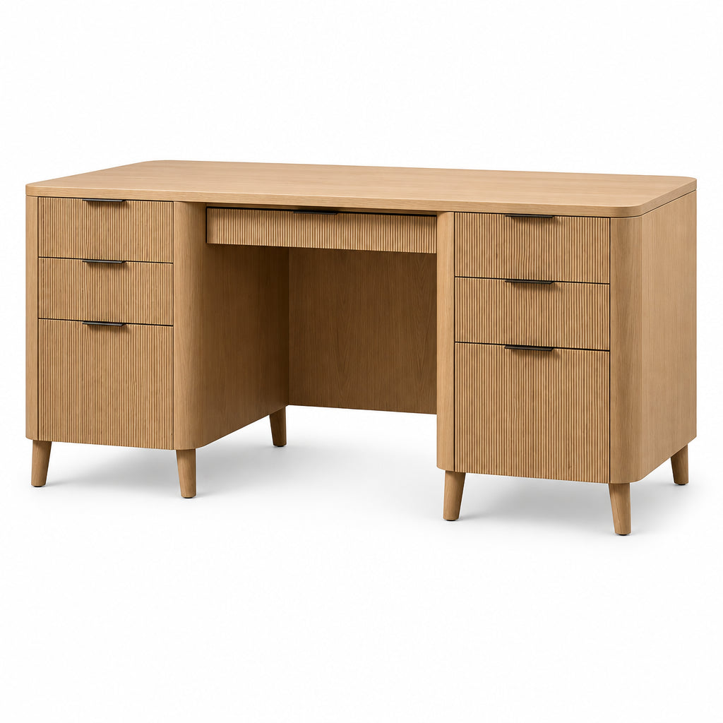 A mid-century modern wooden writing desk with a light oak finish, featuring three drawers on each side and a single open drawer in the center. The desk is styled with a woven basket bowl and two white ceramic vases on top, set against a solid white background.