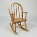 A traditional wooden Amish Bowback Kid's Rocker chair with a curved backrest and armrests on a curved rockers base.