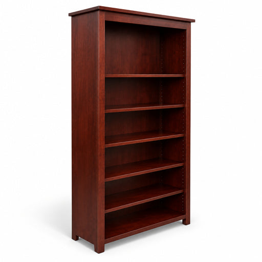 A tall, dark reddish-brown wooden bookcase with five open shelves, photographed in a furniture showroom next to a bed frame.