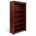 A tall, dark reddish-brown wooden bookcase with five open shelves, photographed in a furniture showroom next to a bed frame.
