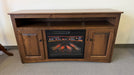 Wooden entertainment console with built-in electric fireplace on a carpeted floor.