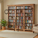 A large wooden bookcase with three tall central panels and a black metal ladder leaning against the middle section, shown on a plain white background.