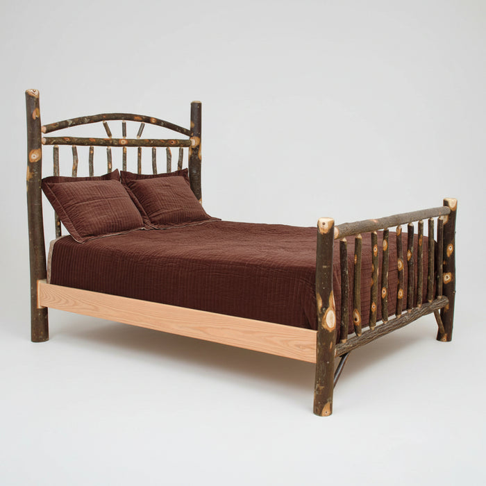 A rustic log-frame bed with a dark brown finish and natural light wood accents, dressed in a brown corduroy comforter and two matching pillows, shown on a plain white background.