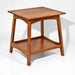 A square wooden side table with a warm medium-brown finish, featuring a top shelf and a slanted front leg, shown on a plain white background.