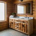 A rustic double-sink bathroom vanity made from natural log-style wood with a gray stone countertop and two white sinks, shown against a light gray background.