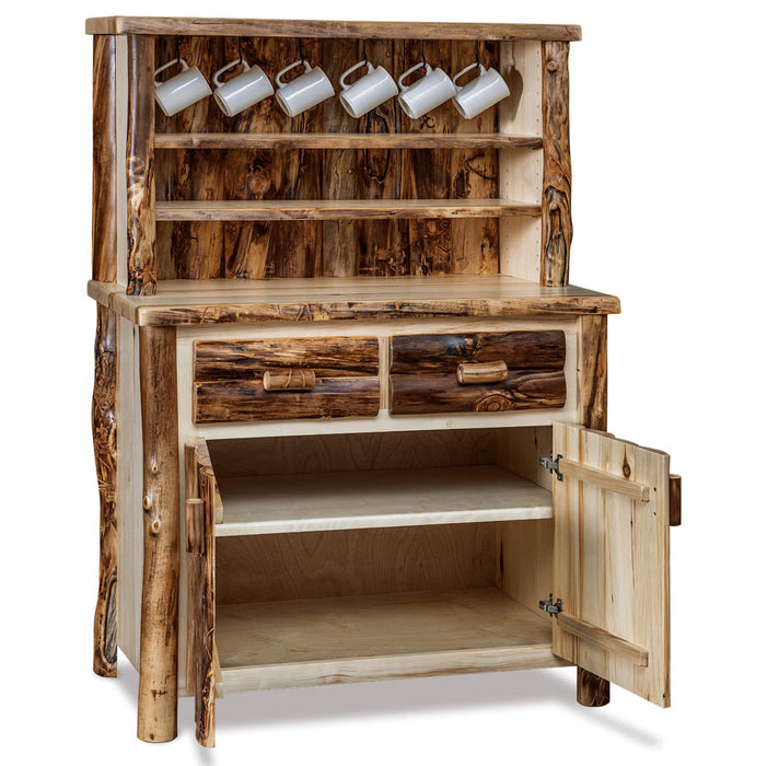 Rustic log-style hutch cabinet with a natural wood finish, featuring a top shelf with six white mugs, two drawers with rustic handles, and an open lower cabinet door showing shelving space.