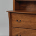 Wooden bookshelf with two drawers on a gray background