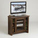 A rustic brown wooden TV stand with glass doors and open shelves, holding a television and electronic devices, set against a plain white background.