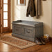 A rustic gray-brown wooden storage bench with two drawers and dark metal handles, shown on a plain white background.
