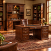 A set of four dark brown wooden home office furniture pieces shown on a white background: a hutch with shelving, an L-shaped desk, a tall office chair, and a tall bookcase.