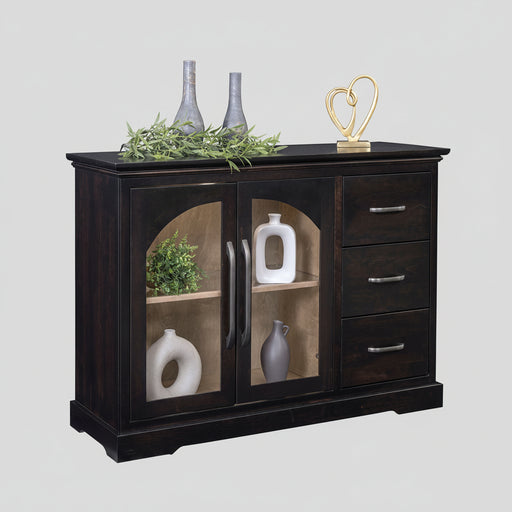 A dark wood sideboard cabinet with two glass-front doors and three drawers, styled with decorative vases, greenery, and a gold heart sculpture on a white background.
