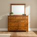 Wooden dresser with mirror on a gray background