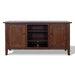 A dark brown wooden media console with two paneled cabinet doors, two open shelves in the center, and small round dark knobs, shown against a plain white background.