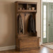 A rustic brown wooden entryway hall tree with an open top shelf, three hanging hooks, a bench seat, and a storage drawer, shown on a plain white background.