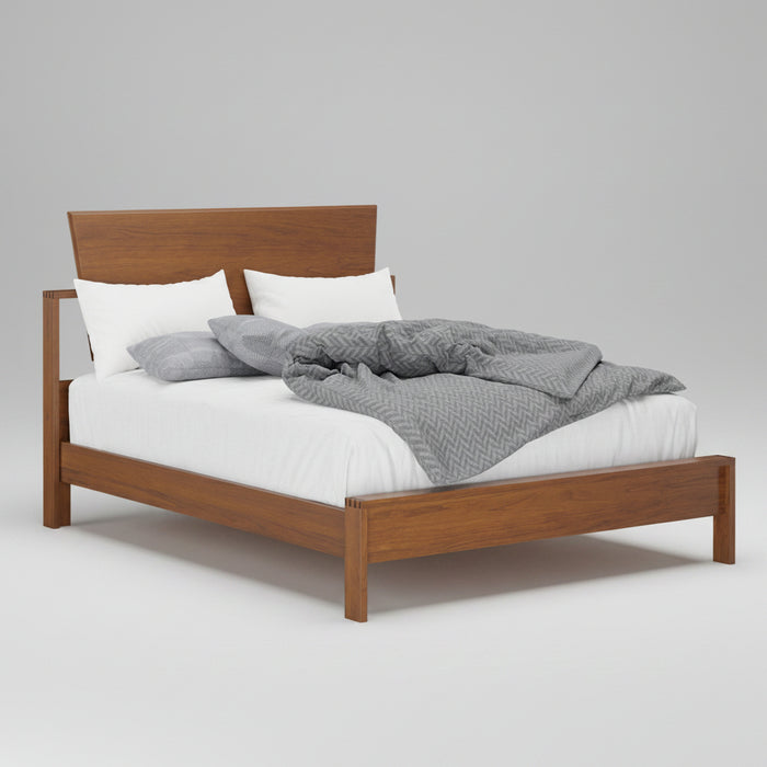 Wooden bed with white bedding and gray blanket on a white background