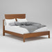 Wooden bed with white bedding and gray blanket on a white background