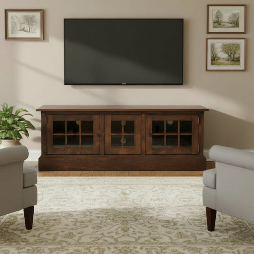 A dark brown wooden media console with three glass-paneled doors, shown on a light gray gradient background.