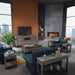 Modern living room with blue sofa, gray coffee table, and TV stand.